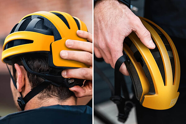 oranger Klapphelm von Fend in der Hand